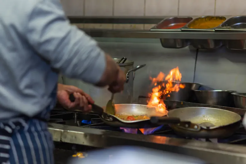 Chef cooking over flames at Concord Tandoori, Washington, food photography by You Can Fly Media