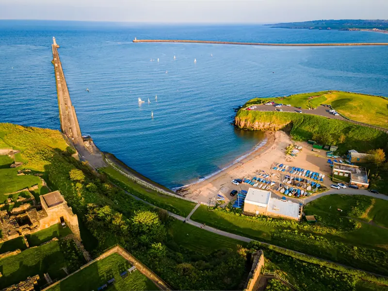 Drone photograph of a pier, beach and clifftop on the North East coast