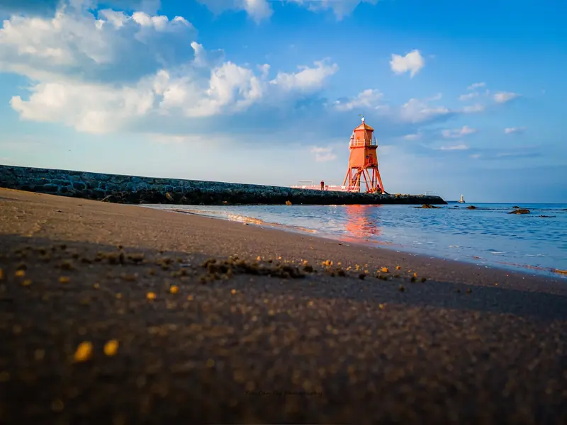 Herd Groyne lighthouse on South Shields beach at golden hour, photographed from the sand