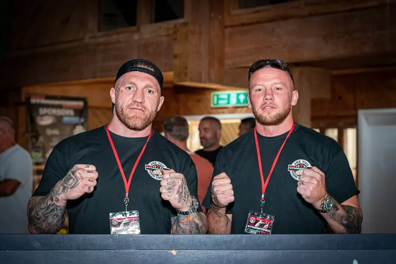 Two fighters posing with their fists up at a fight night weigh-in