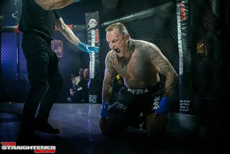 MMA fighter roaring in the cage under lights at a North East fight night