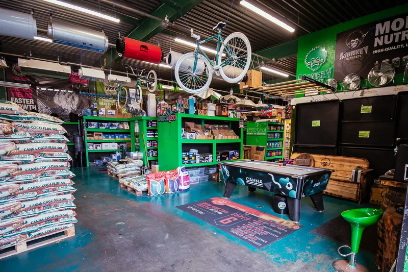 Inside the Hydro Pro Washington hydroponics shop, with stocked green shelving, growing media and a pool table in the customer lounge