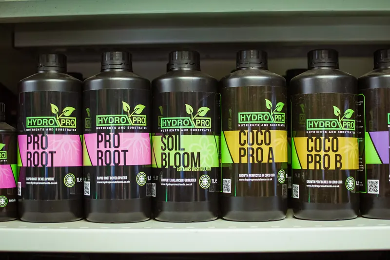 A row of Hydro Pro own-brand nutrient bottles, including Pro Root, Soil Bloom and Coco Pro, on a shop shelf