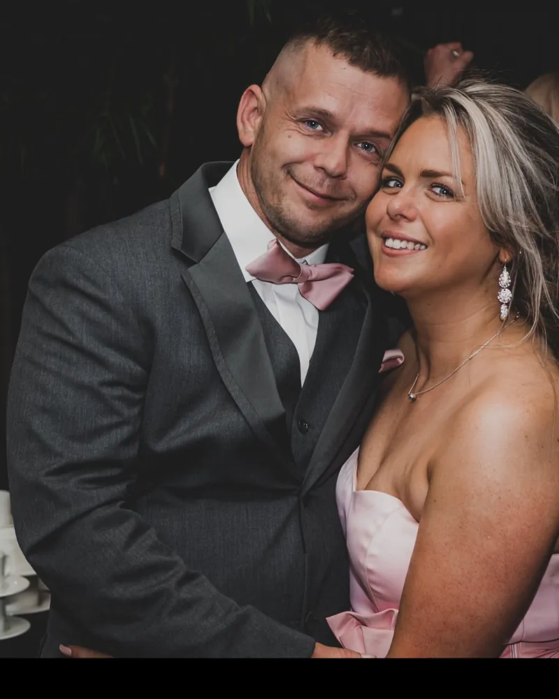 Karn and Laura, the founders of You Can Fly Media, smiling together at an evening event