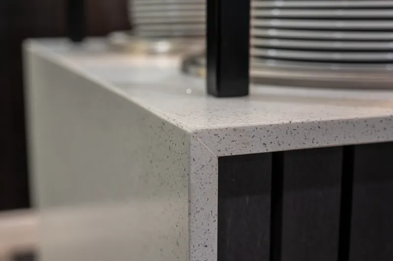 Close-up of a speckled worktop edge and waterfall end